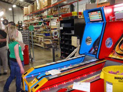 Consortium member Tonja Brabazon from Brabazon Pump tries her luck on an Alley Bowler during a consortium meeting hosted by Bay Tek Games in Pulaski, WI.